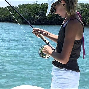 Girl catching bonefish in Belize with Abbie Marin Fly Fishing